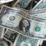 This Oct. 24, 2016 file photo shows dollar bills in New York. (AP Photo/Mark Lennihan, File)