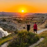The Wind Canyon Trail in the south unit of Theodore Roosevelt National Park boasts dramatic vistas along the Little Missouri River where budding cottonwood trees soften the rugged badlands landscape. Credit: North Dakota Tourism