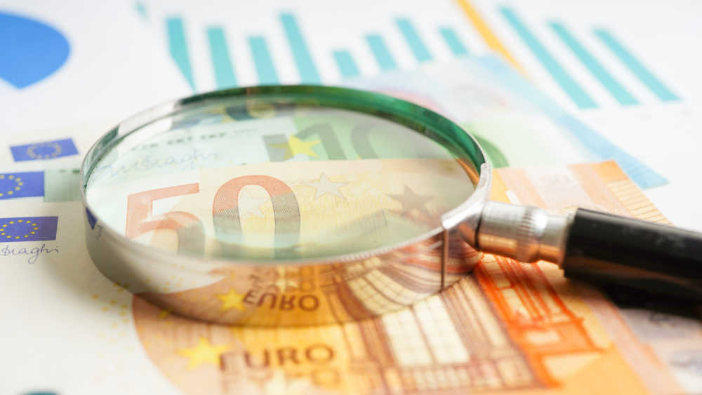 magnifying glass on top of euro notes