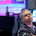 A trader reacts after the closing bell on the floor at the New York Stock Exchange on April 15, 2025.