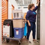 person puts items in a self storage unit