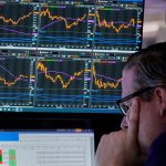 Specialist Gregg Maloney works at his post on the floor of the New York Stock Exchange, Monday, April 28, 2025.