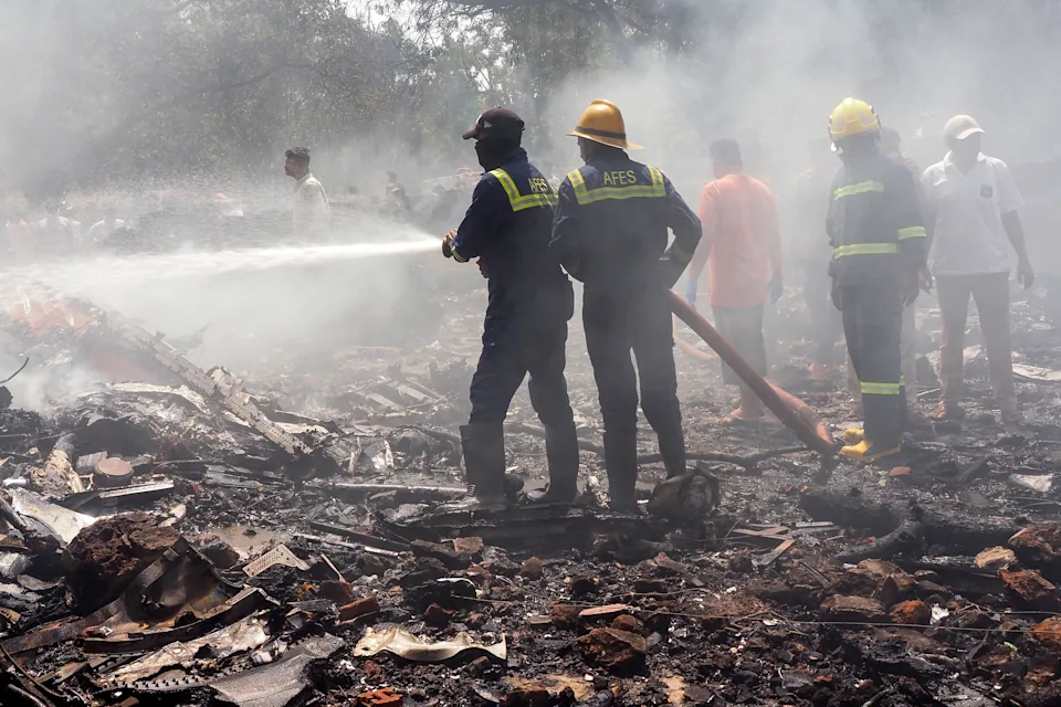 Firefighters work at the site where Air India flight 171 crashed in a residential area near the airport in Ahmedabad on June 12. (Sam Panthaky/AFP via Getty Images)