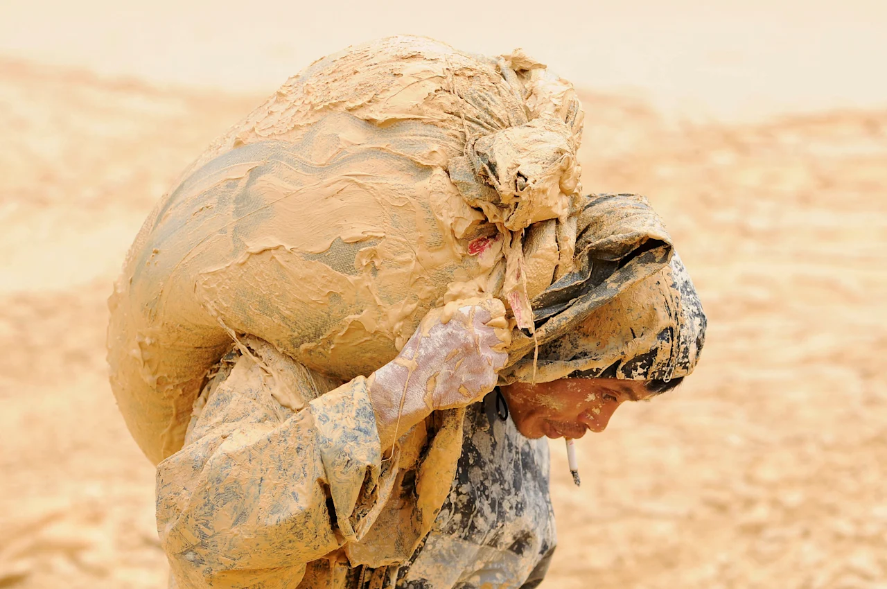 FILE PHOTO: A man works at the site of a rare earth metals mine at Nancheng county, Jiangxi province, China, October 20, 2010. REUTERS/Stringer/File Photo